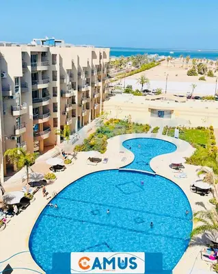 an aerial view of a resort with a large swimming pool at CAMUS 110 A, Princess Resort in Hurghada
