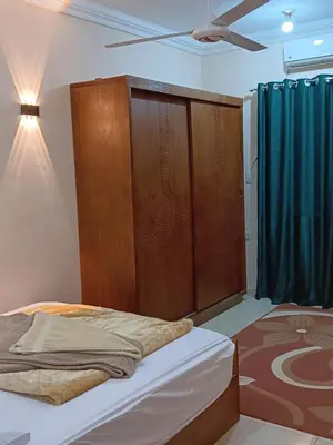 a bedroom with a bed with a wooden headboard at Dream sea Apartment in Hurghada