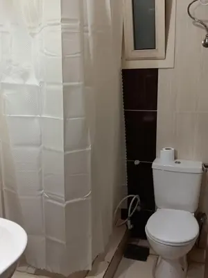 a white bathroom with a toilet and a sink at Dream sea Apartment in Hurghada