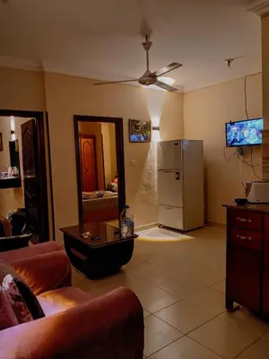 a living room with a refrigerator and a couch at Dream sea Apartment in Hurghada