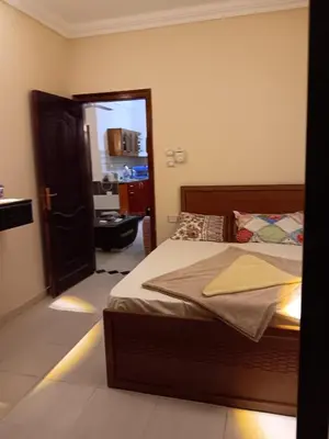 a bedroom with a bed and a open door at Dream sea Apartment in Hurghada