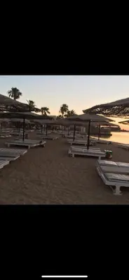 a group of picnic tables on a sandy beach at Mashrabiya hotel in Hurghada