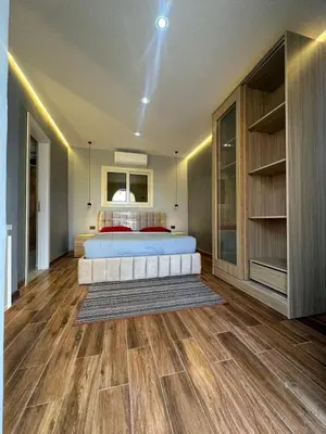 a bedroom with a bed and a wooden floor at Mashrabiya hotel in Hurghada