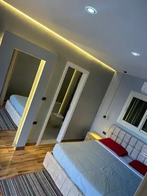 a bedroom with a large bed and two windows at Mashrabiya hotel in Hurghada