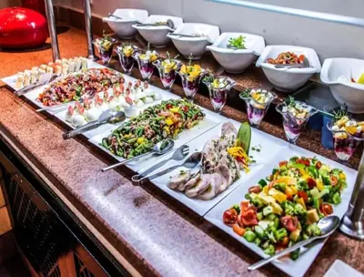 a buffet with many plates of food on a table at Nile Cruise FB 3 Nights Aswan Luxor in Aswan