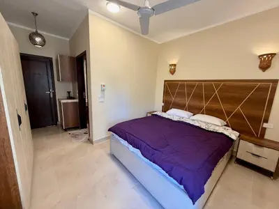 a bedroom with a large purple bed in a room at Sheherazade Hotel Nile Villa in Luxor
