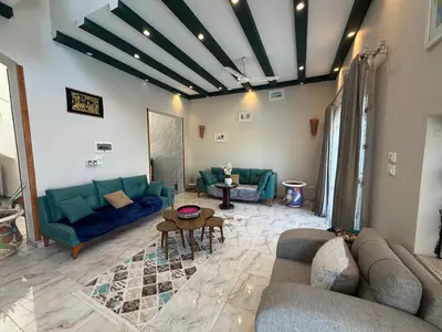 a living room with blue couches and a table at Sylvie guest house I in Luxor