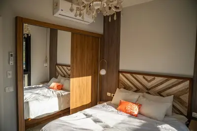 a bedroom with two beds and a mirror at 4 Bedrooms, Luxury Villa Makadi Heights in Hurghada
