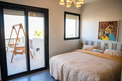 a bedroom with a bed and a sliding glass door at 4 Bedrooms, Luxury Villa Makadi Heights in Hurghada