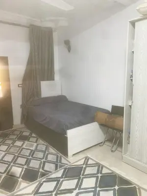 a bedroom with a bed and a table and a mirror at Nubian rise in Aswan