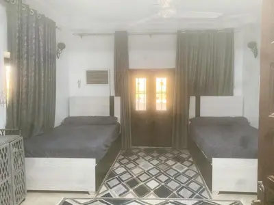 a bedroom with two beds and a window at Nubian rise in Aswan