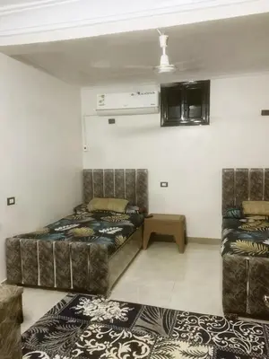 a bedroom with a bed and a couch in a room at Nubian rise in Aswan