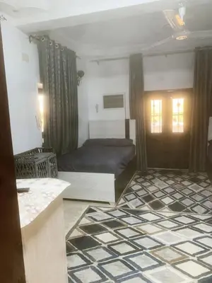 a bedroom with a bed and a door in a room at Nubian rise in Aswan