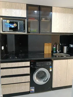 a kitchen with a washing machine and a microwave at scandic resort sea view in Hurghada