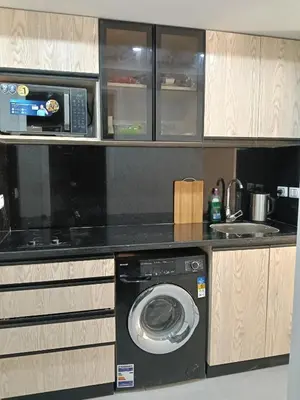 a kitchen with a washing machine and a microwave at scandic resort sea view in Hurghada