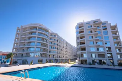 two large buildings with a swimming pool in front of a building at scandic resort sea view in Hurghada