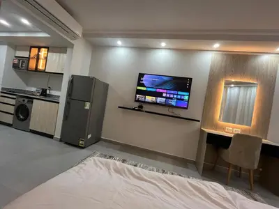 a living room with a flat screen tv on the wall at scandic resort sea view in Hurghada