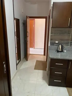 a kitchen with a sink and a door to a hallway at Tiba A F B View in Hurghada