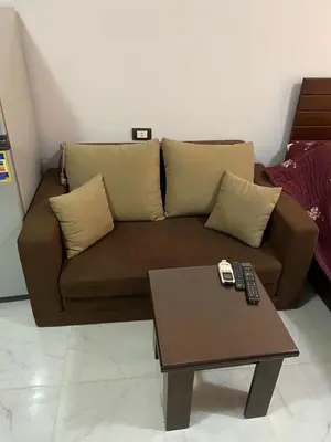 a brown couch in a living room with a coffee table at Tiba A F B View in Hurghada