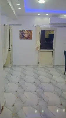 a room with a white room with a white floor at اهلا بيكم في بيتنا in Jazīrat al ‘Awwāmīyah