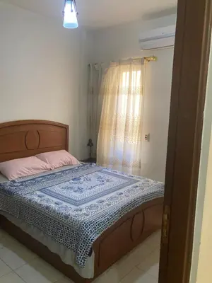 a bedroom with a bed and a window at M-2bedroom flat with garden in Hurghada