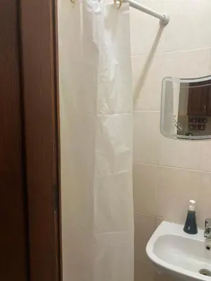 a bathroom with a shower curtain and a sink at M-2bedroom flat with garden in Hurghada