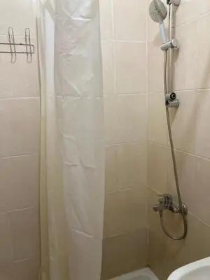 a bathroom with a shower with a toilet and a sink at M-2bedroom flat with garden in Hurghada