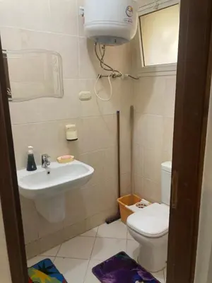 a small bathroom with a sink and a toilet at M-2bedroom flat with garden in Hurghada