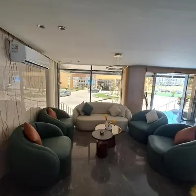 a living room with couches and a table at Tiba Golden Resort one bedroom in Hurghada