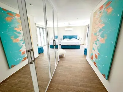 a room with a bed and a glass door at Supreme Beachfront 3BR Villa Soma bay with Garden in Hurghada