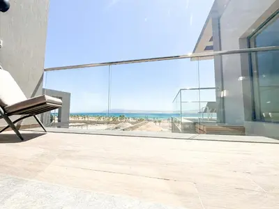 a chair on a balcony with a view of the ocean at Supreme Beachfront 3BR Villa Soma bay with Garden in Hurghada