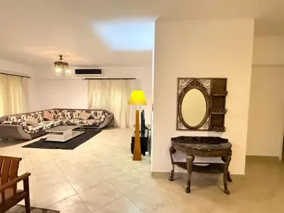a living room with a couch and a mirror at Spacious 3BR Apartment - Al Dora Resort, Hurghada in Hurghada