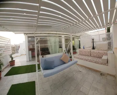 a living room with a blue couch in a building at White Roof - Hurghada in Hurghada