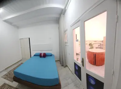 a small room with a bed and a window at White Roof - Hurghada in Hurghada