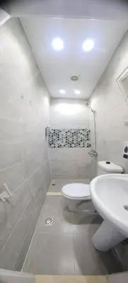 a white bathroom with a sink and a toilet at White Roof - Hurghada in Hurghada
