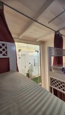 a bedroom with a bed and a large window at White Roof - Hurghada in Hurghada
