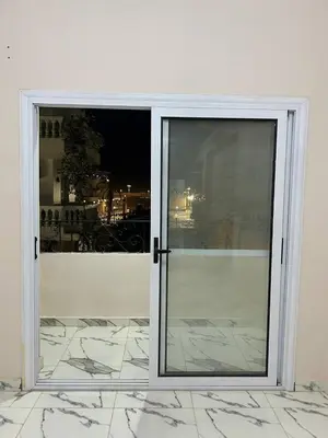 a sliding glass door with a view of a building at The Nile flat in Luxor