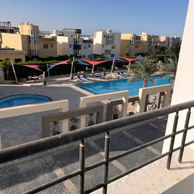 a view of the pool from the balcony of a resort at Modern Retreat with Red Sea View - Fanadir bay in Hurghada