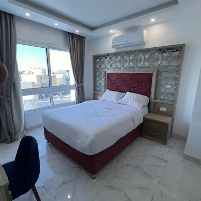 a bedroom with a large bed and a large window at Modern Retreat with Red Sea View - Fanadir bay in Hurghada