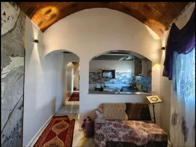 a living room with a bed and a mirror at Rammy Guest House in Aswan