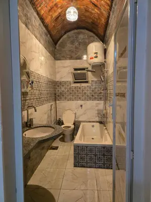 a bathroom with a tub and a toilet and a sink at Rammy Guest House in Aswan