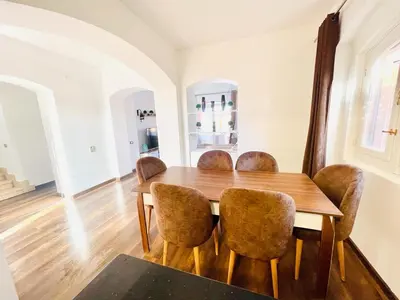 a dining room with a wooden table and chairs at 5 bedroom villa with private pool west golf elgouna in Hurghada