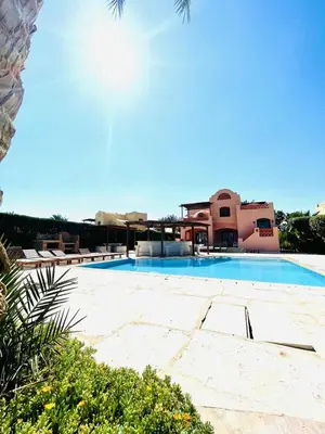 a large swimming pool in front of a building at 5 bedroom villa with private pool west golf elgouna in Hurghada