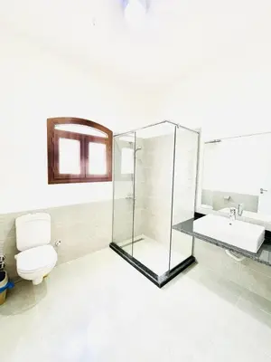a bathroom with a glass shower and a toilet at 5 bedroom villa with private pool west golf elgouna in Hurghada