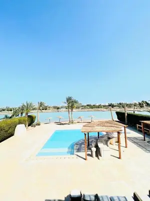 a resort pool with a view of the water at 5 bedroom villa with private pool west golf elgouna in Hurghada