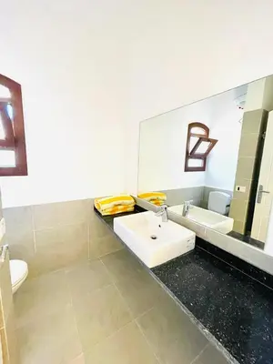 a bathroom with a sink and a mirror at 5 bedroom villa with private pool west golf elgouna in Hurghada