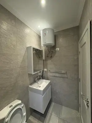 a bathroom with a white sink and a toilet at Aqua blue bay in Hurghada