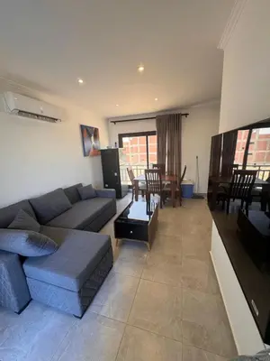 a living room with a couch and a flat screen tv at Aqua blue bay in Hurghada