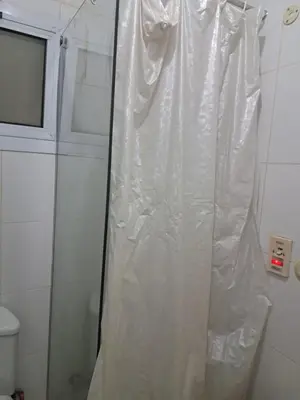 a plastic shower curtain in a bathroom with a toilet at Desert Bearl compound in Hurghada