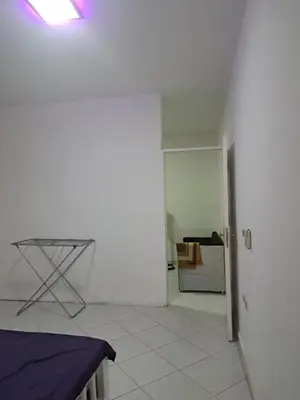a white room with a table and a refrigerator at Desert Bearl compound in Hurghada